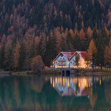 Sill Plate Builders. A framed lake house at dusk.